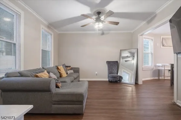 a living room with furniture and a chandelier