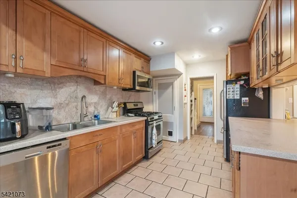 a kitchen with stainless steel appliances granite countertop a refrigerator sink and cabinets
