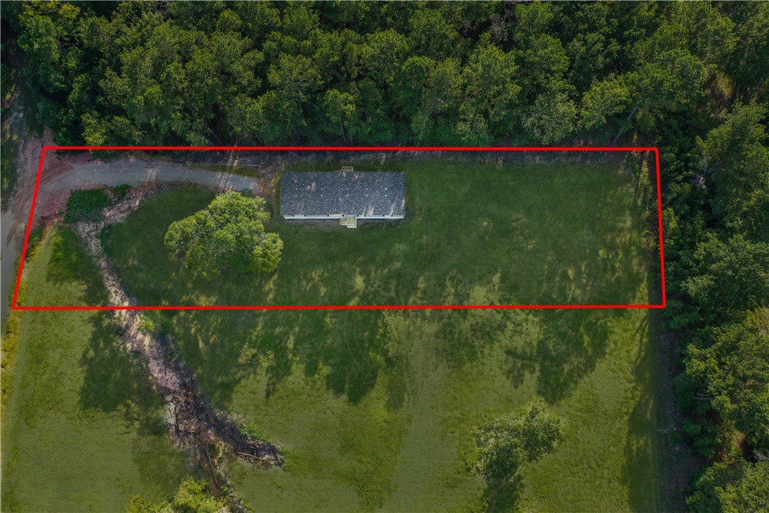 4845 Long Shadows Road Navasota, TX 77868 - Photo 2 of 13 5 bedroom home on 1 acre lot backs up to mature wooded lot. Grass is digitally enhanced