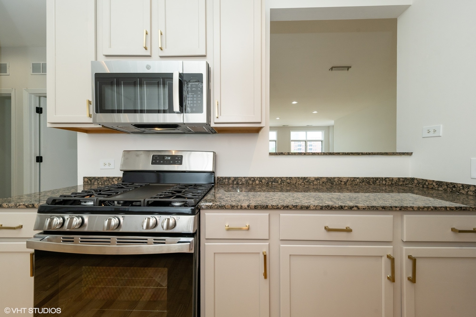 330 North Clinton Street, Unit 303 Chicago, IL 60661 - Photo 7 of 14 a kitchen with stainless steel appliances granite countertop a stove and a microwave