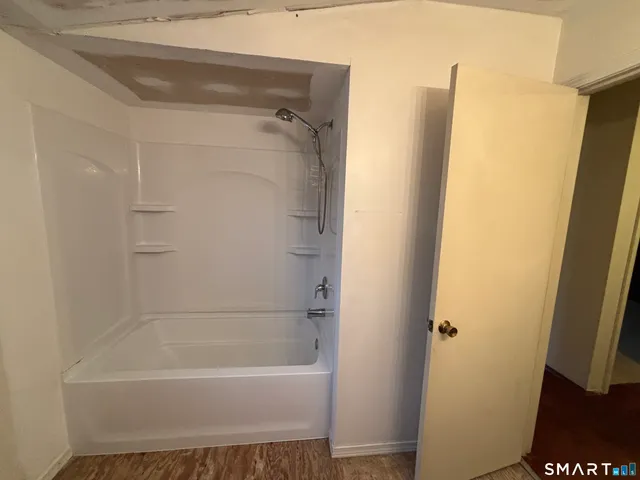 a bathroom with a sink toilet and mirror