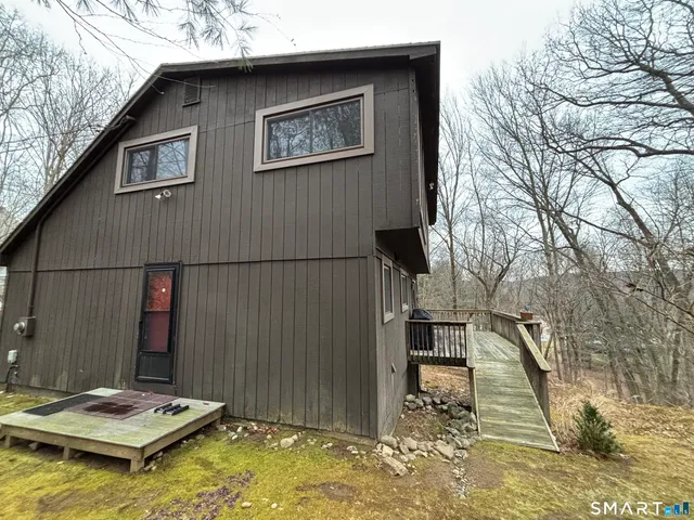 a backyard of a house with table and chairs