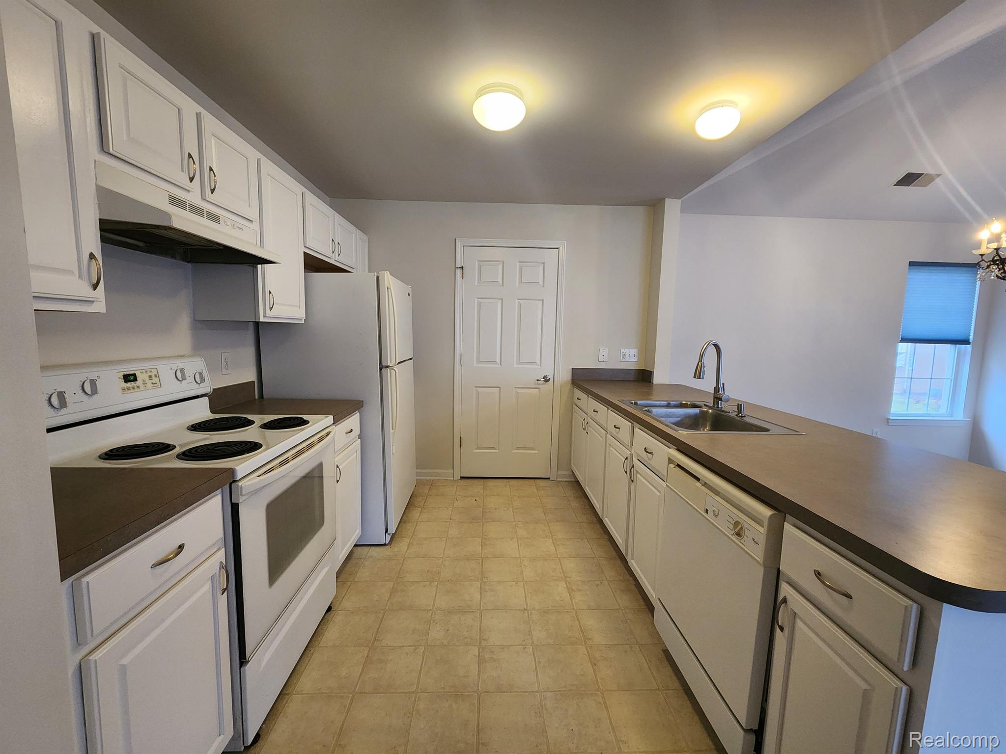 1100 Rial Lake Drive Howell, MI 48843 - Photo 10 of 19 Galley Kitchen. Door leads to laundry/mechanicals