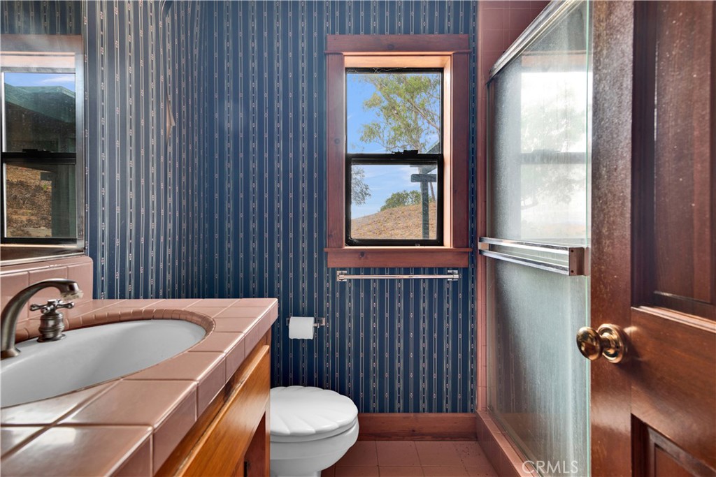 7550 Rancho Verano Place Paso Robles, CA 93446 - Photo 16 of 35 a bathroom with a granite countertop sink toilet and shower