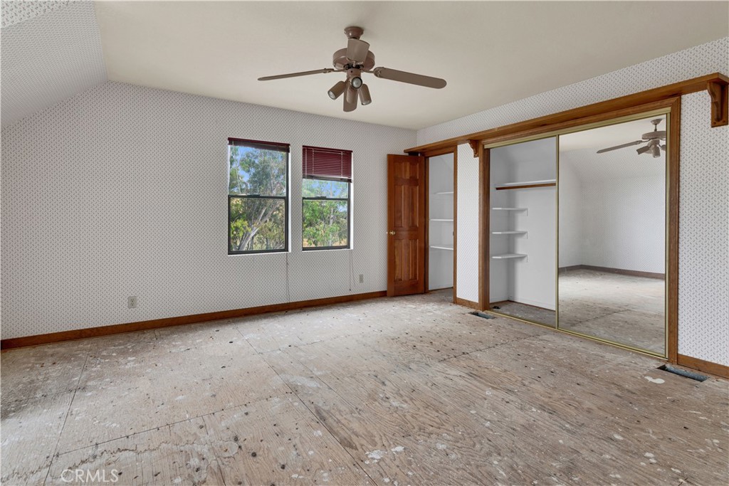 7550 Rancho Verano Place Paso Robles, CA 93446 - Photo 17 of 35 an empty room with chandelier fan and windows