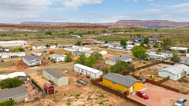 740 Riddle Drive Fredonia, AZ 86022 - Photo 19 of 20 Residential properties situated in a desert landscape, featuring a prominent mesa in the background