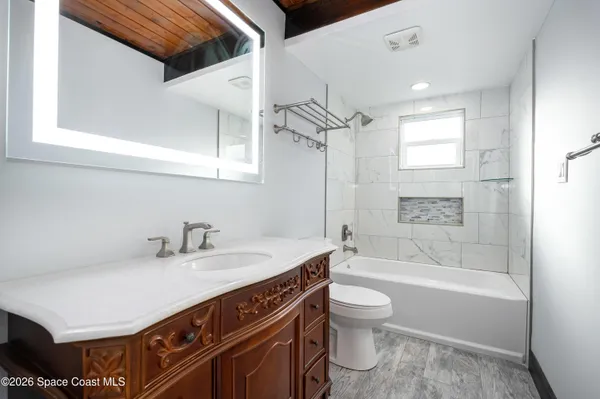 a bathroom with a sink a toilet and a bathtub