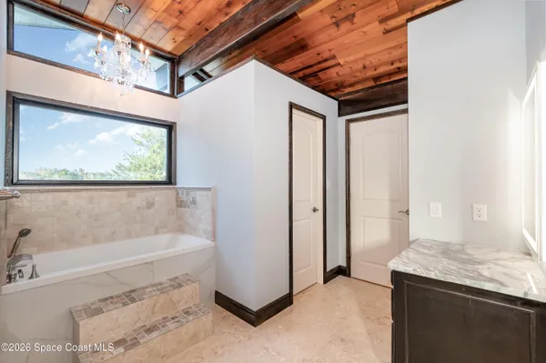 a bathroom with a tub and a window