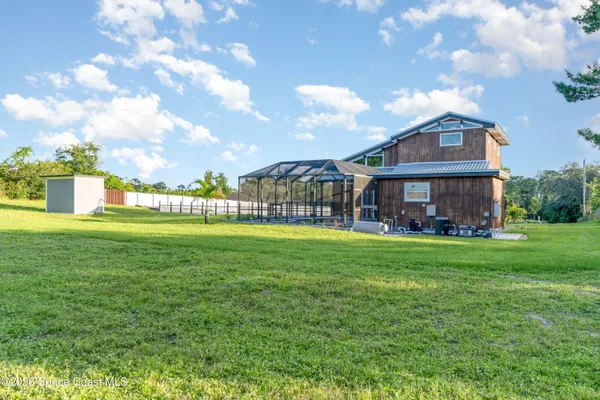 a view of a house with swimming pool and sitting area