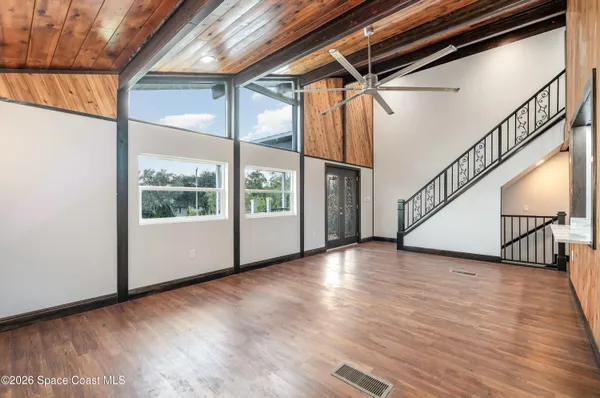 a view of an entryway with wooden floor