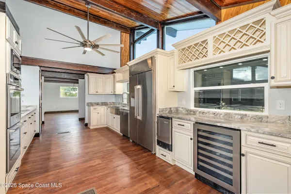a kitchen with stainless steel appliances granite countertop a refrigerator and a stove top oven
