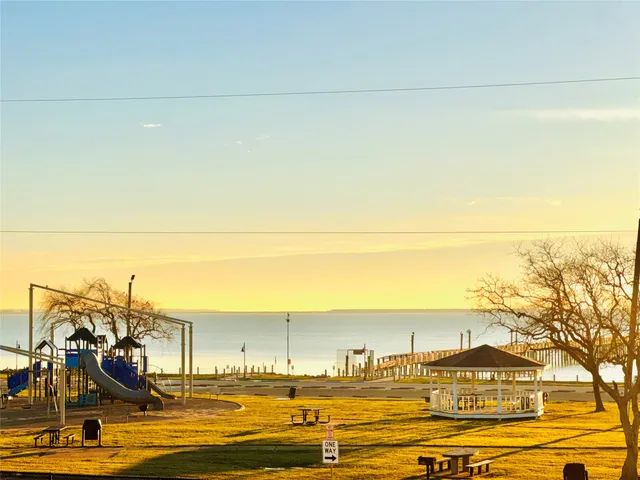 a view of a swimming pool with an ocean from a balcony
