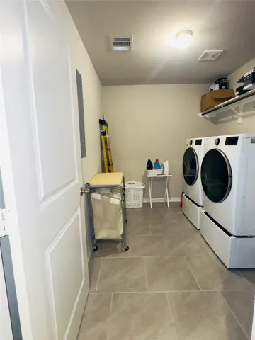 a spacious bedroom with a bed and window