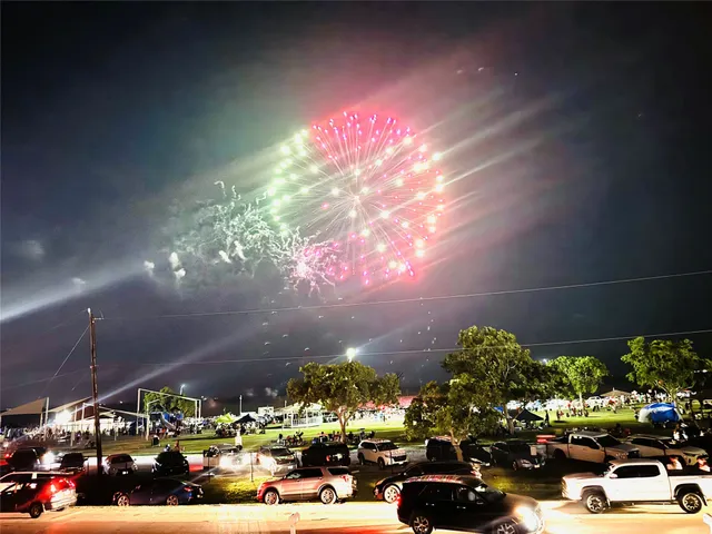 a kitchen with stainless steel appliances kitchen island granite countertop a refrigerator and a stove top oven