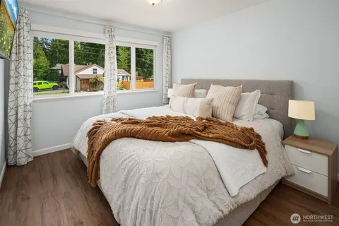 a bed sitting in a bedroom next to a window