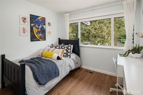 a bedroom with bed and a window