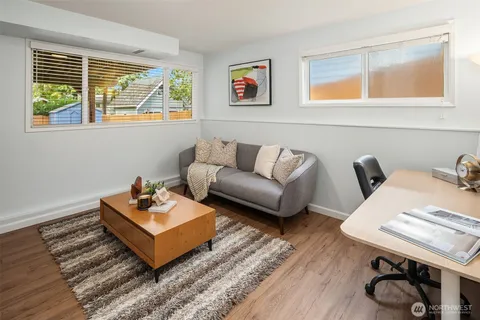 a living room with furniture a rug and a window