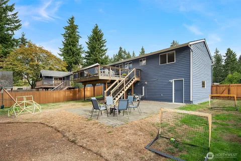 a backyard of a house with table and chairs