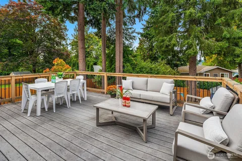 an outdoor sitting area with furniture and wooden floor