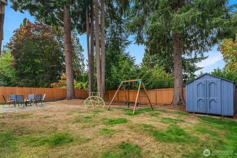 a view of a backyard with a table and chairs