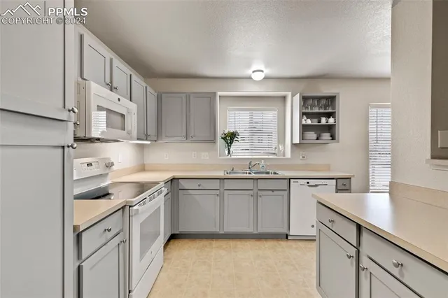 a kitchen with a sink stove and refrigerator