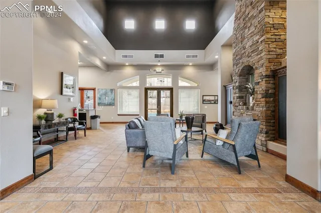 a living room with fireplace furniture and a chandelier
