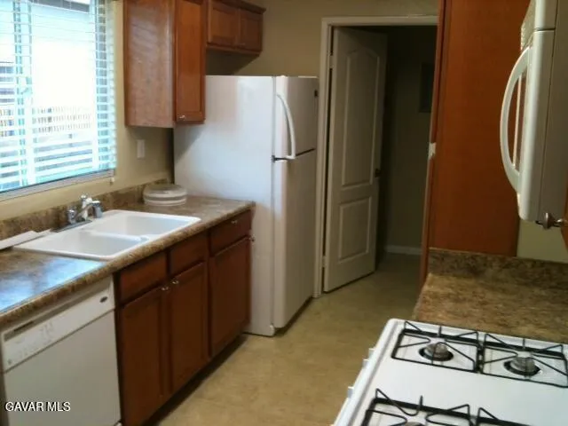 a kitchen with a sink stove and refrigerator