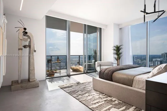 a living room with furniture and a floor to ceiling window