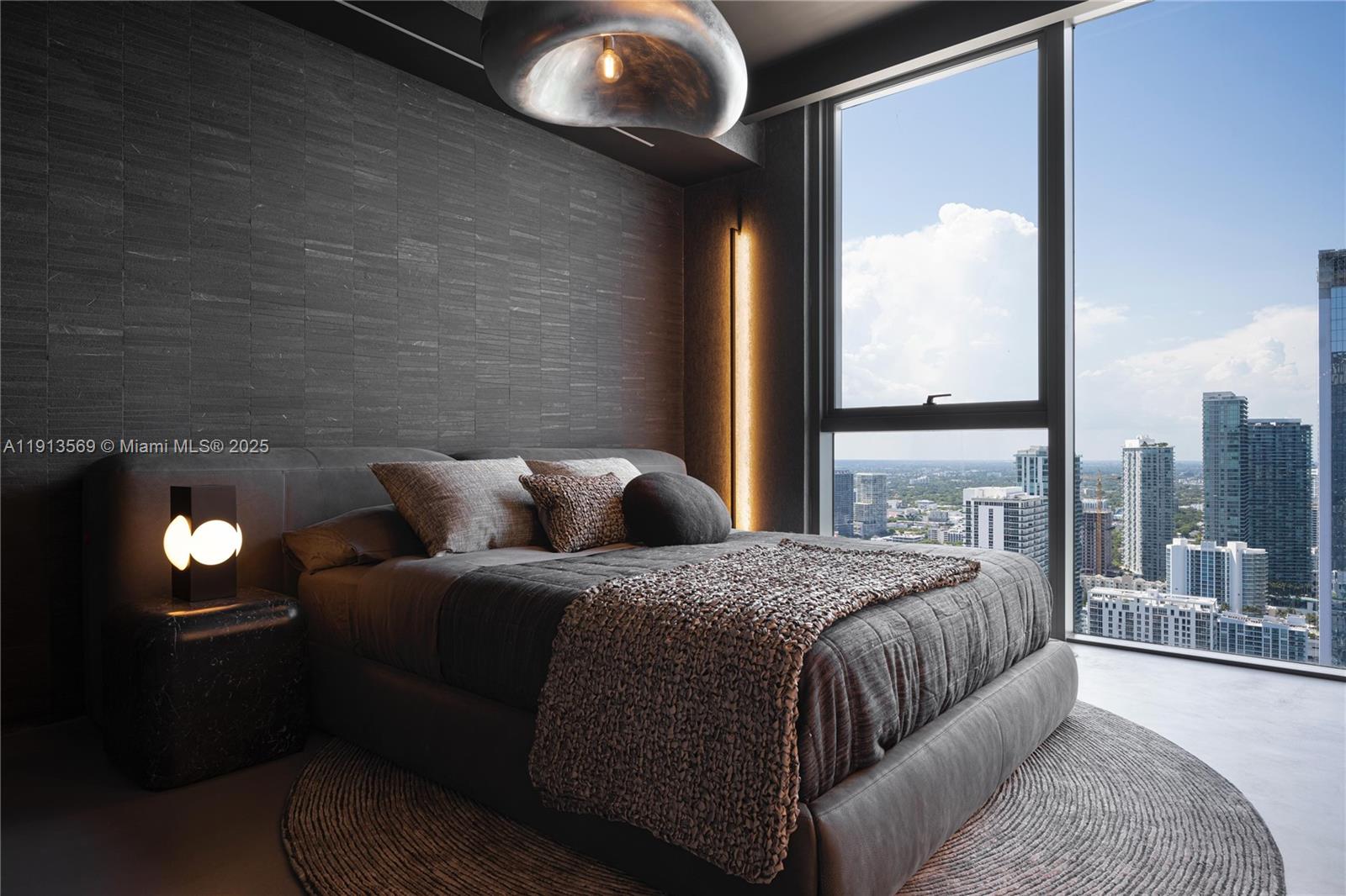 788 Northeast 23rd Street, Unit 4102 Miami, FL 33137 - Photo 17 of 41 a bedroom with a bed and a lamp next to a window