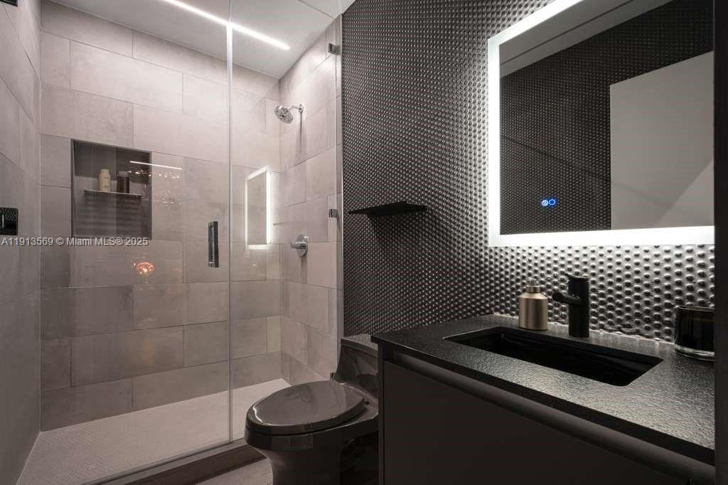 788 Northeast 23rd Street, Unit 4102 Miami, FL 33137 - Photo 18 of 41 a bathroom with a sink a toilet and shower
