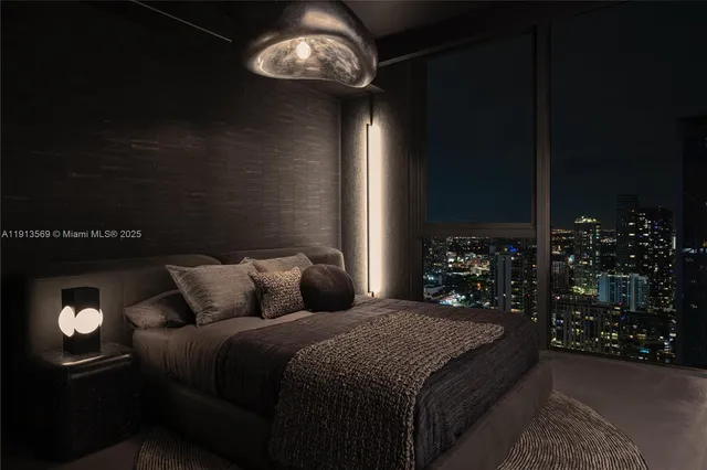 a bedroom with a bed and a lamp