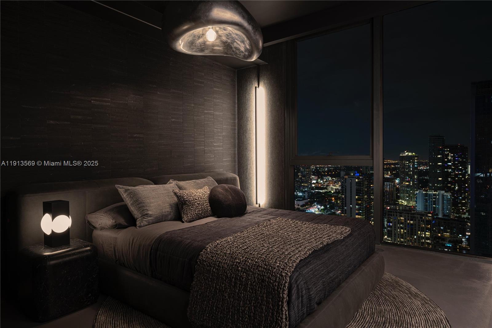 788 Northeast 23rd Street, Unit 4102 Miami, FL 33137 - Photo 24 of 41 a bedroom with a bed and a chandelier