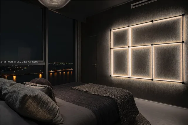 a bedroom with a bed and lamp with the outside view