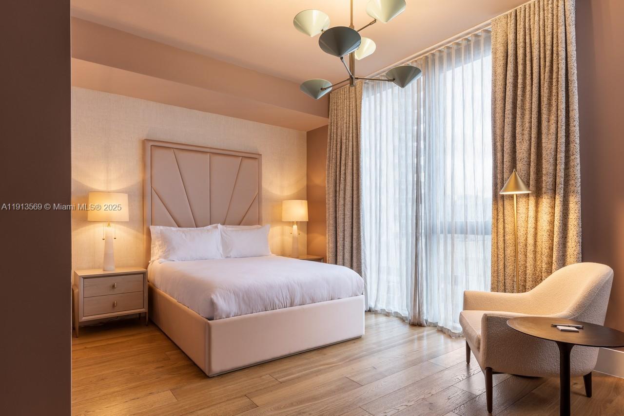 788 Northeast 23rd Street, Unit 4102 Miami, FL 33137 - Photo 37 of 41 a bedroom with a bed and a chair