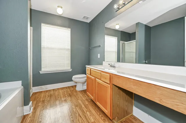 a bathroom with a bathtub and a window
