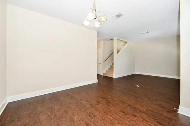 a view of a room with wooden floor and white walls
