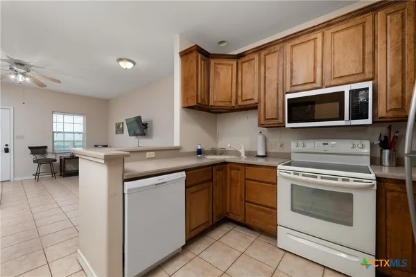 a kitchen with cabinets stainless steel appliances and a sink