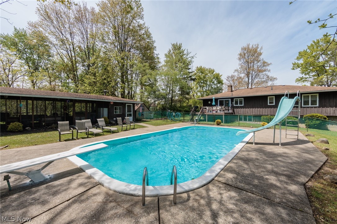 2170 Norton Road Stow, OH 44224 - Photo 2 of 48 Rectangular swimming pool with a diving board and slide, surrounded by concrete decking