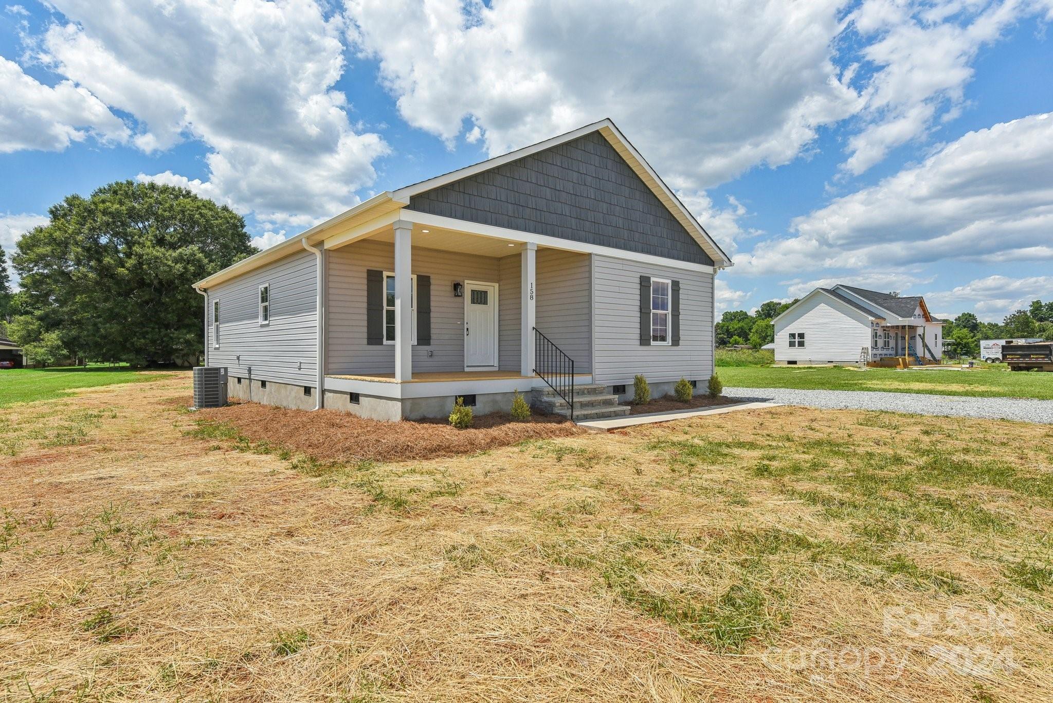 a view of house with backyard and garden