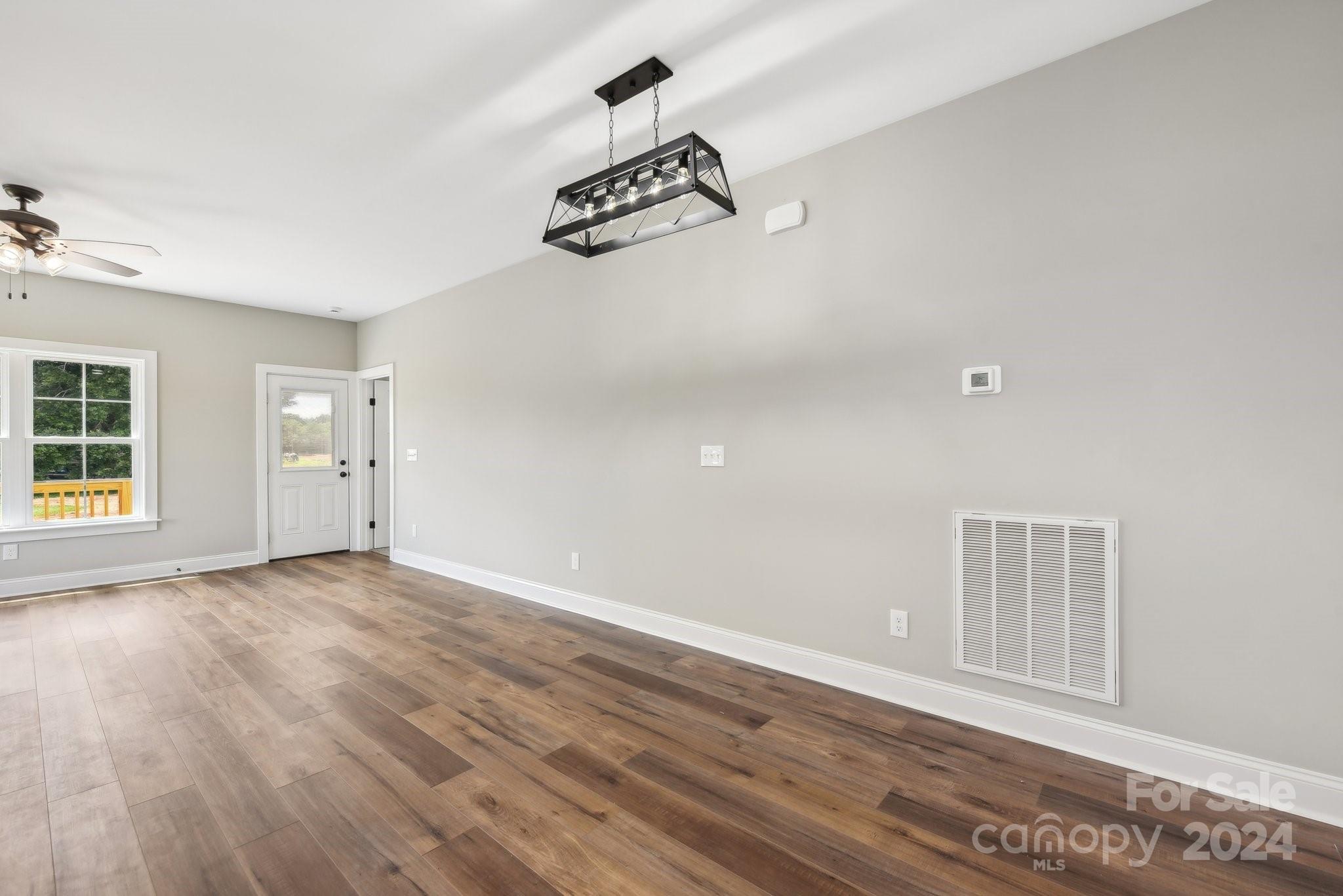 158 Wetmore Road Woodleaf, NC 27054 - Photo 14 of 33 wooden floor in an empty room with a window