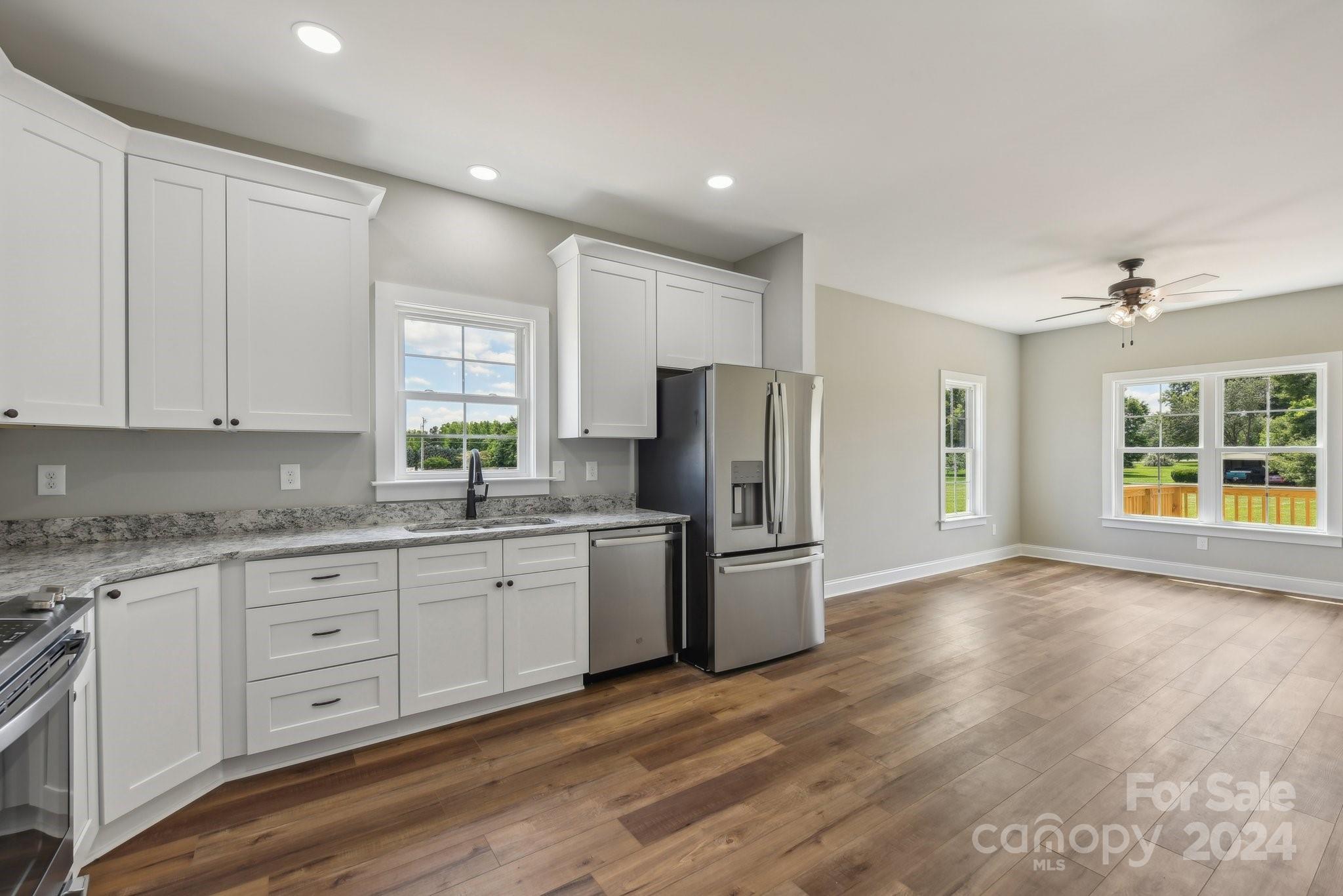 158 Wetmore Road Woodleaf, NC 27054 - Photo 16 of 33 a kitchen with stainless steel appliances granite countertop a refrigerator and a stove top oven