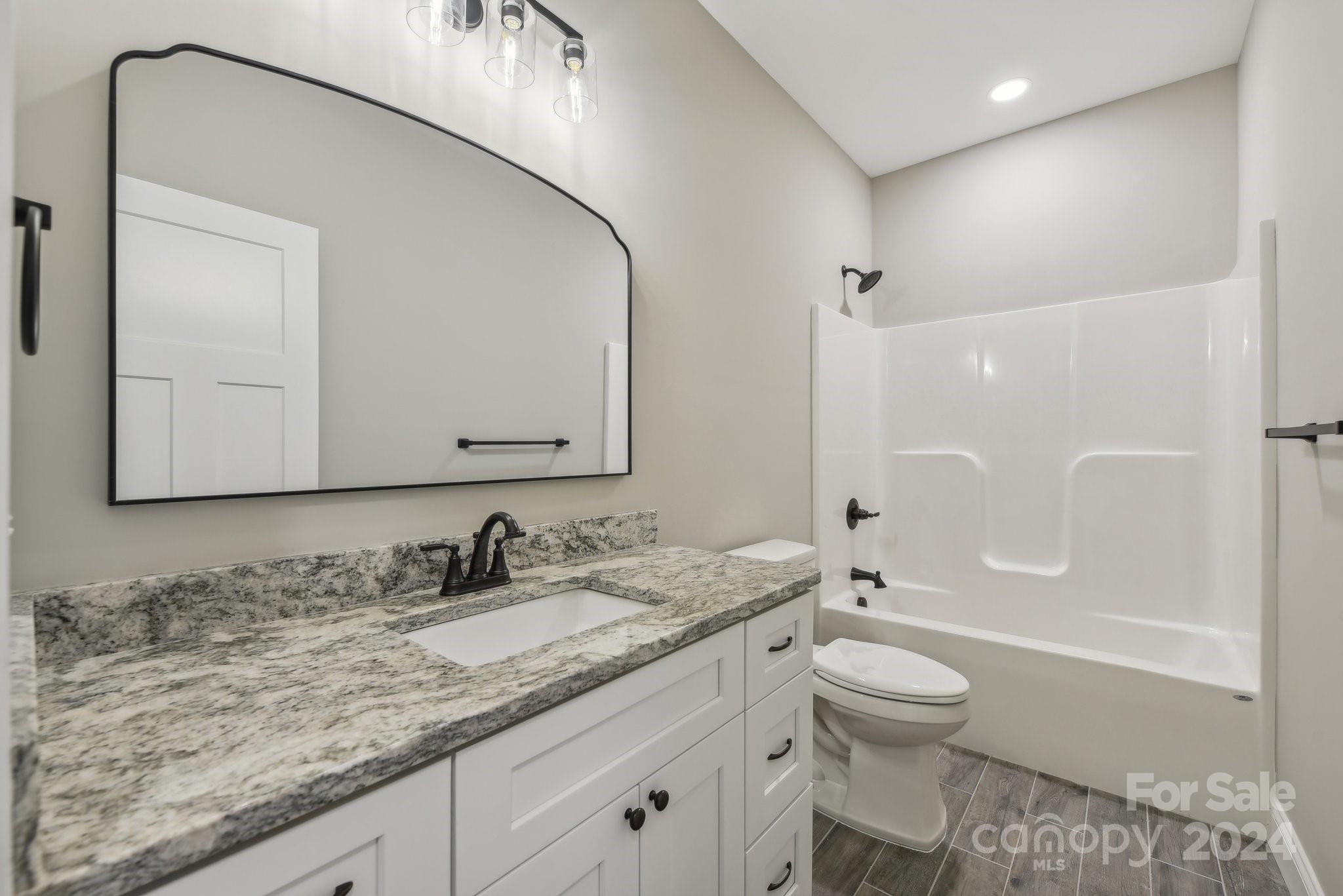 158 Wetmore Road Woodleaf, NC 27054 - Photo 23 of 33 a bathroom with a granite countertop sink toilet and shower