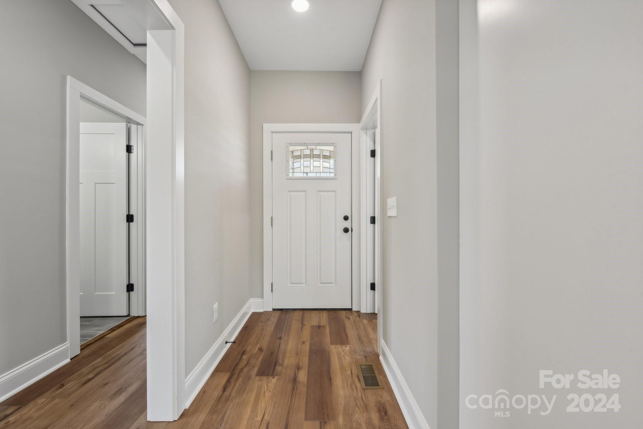 158 Wetmore Road Woodleaf, NC 27054 - Photo 6 of 33 a view of a hallway with wooden floor