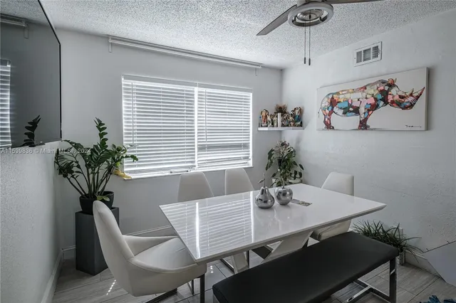 a car parked in front of a house with a garden