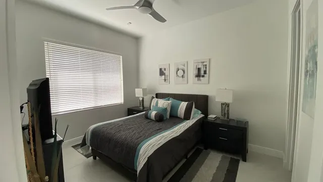 a bedroom with a bed and a window