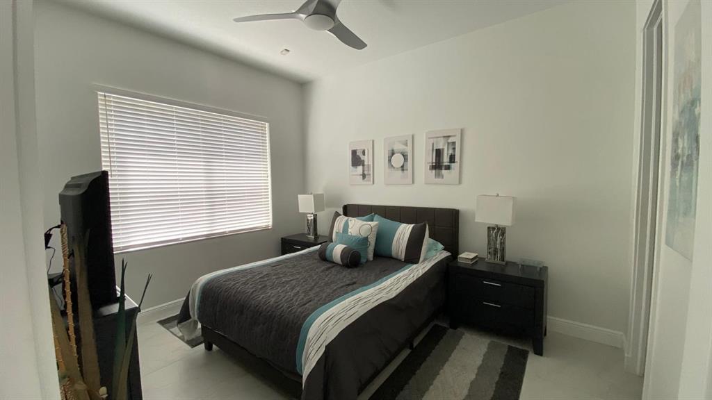 830 Bailey Street Boca Raton, FL 33487 - Photo 14 of 24 a bedroom with a bed and a window