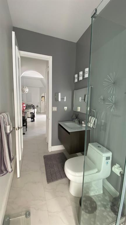 830 Bailey Street Boca Raton, FL 33487 - Photo 17 of 24 a bathroom with a toilet sink and mirror