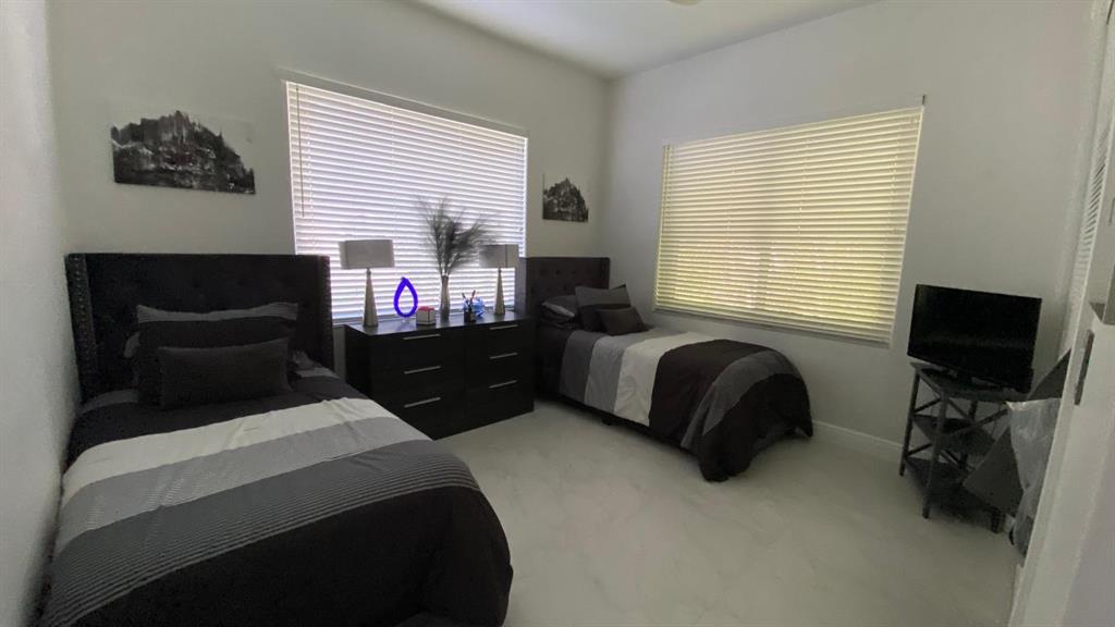830 Bailey Street Boca Raton, FL 33487 - Photo 18 of 24 a bedroom with a bed and a television