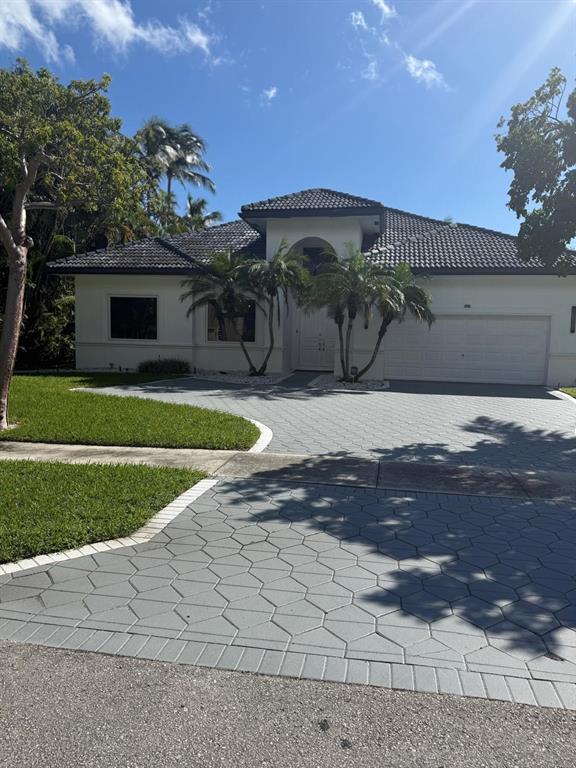 830 Bailey Street Boca Raton, FL 33487 - Photo 2 of 24 a front view of a house with a yard and garage