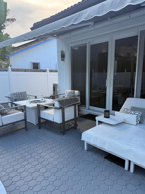 830 Bailey Street Boca Raton, FL 33487 - Photo 24 of 24 a living room with patio furniture and a wooden floor